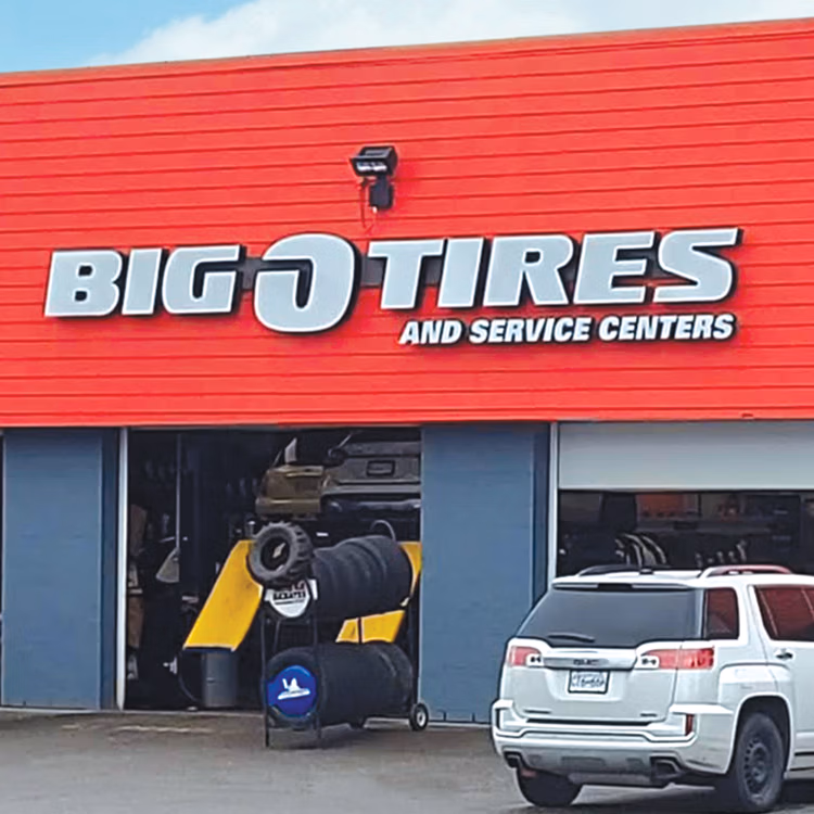 An independent Big O Tires store owner outside their shop